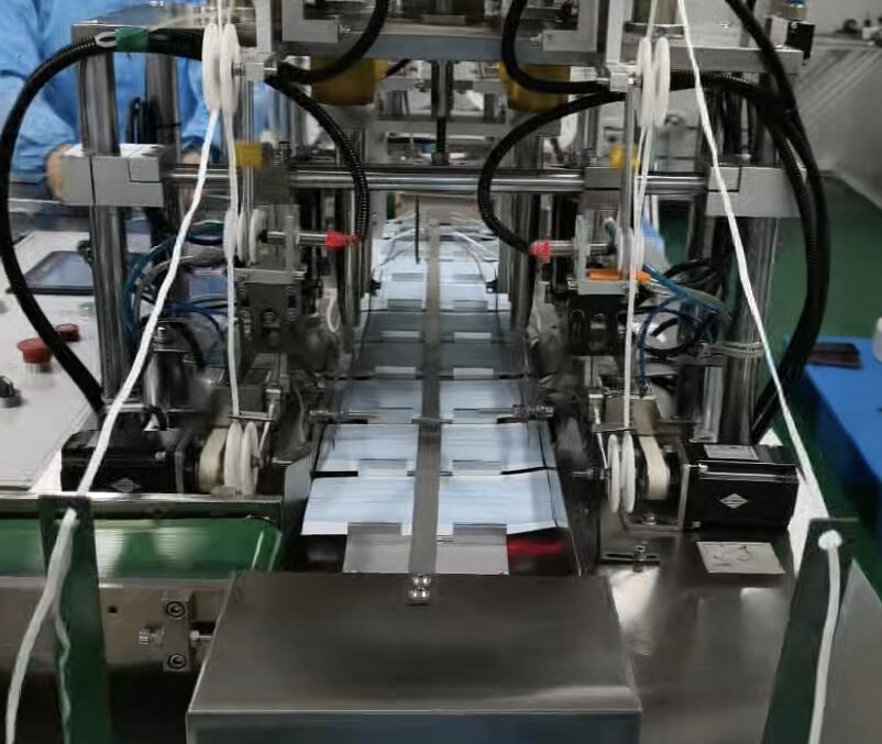 Mask folding and packaging line